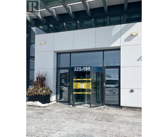 The entrance to a building with a glass door and a yellow sign on it.
