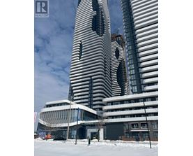A tall building with a unique design stands next to a smaller building in a snowy landscape.