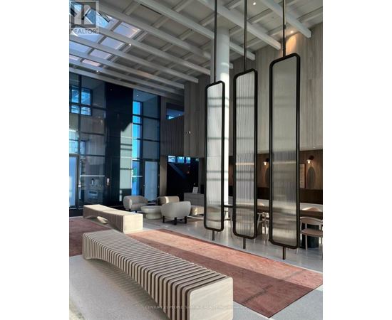 A modern interior space with a long bench and tall vertical panels.