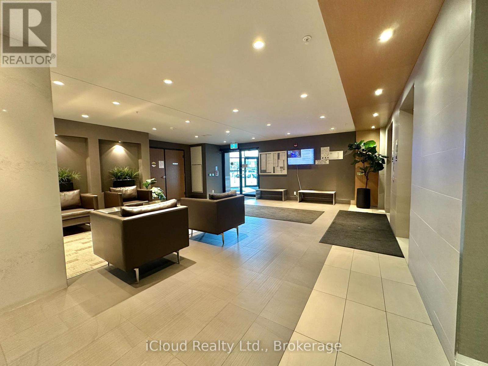 A spacious lobby with a reception desk and comfortable seating areas.