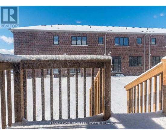 A snow-covered building with a wooden fence in front.
