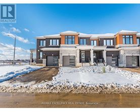 A large, modern house with a snow-covered ground in front.