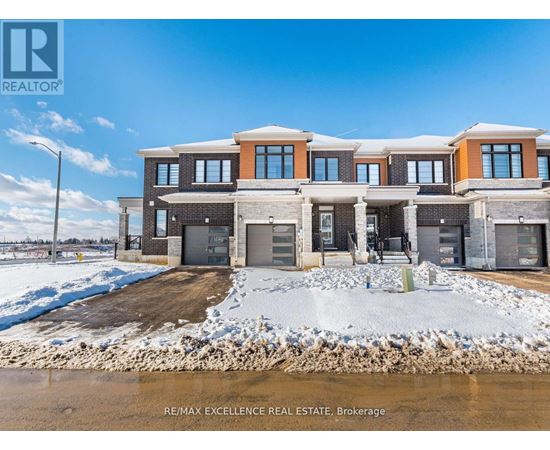 A large, modern house with a snow-covered ground in front.