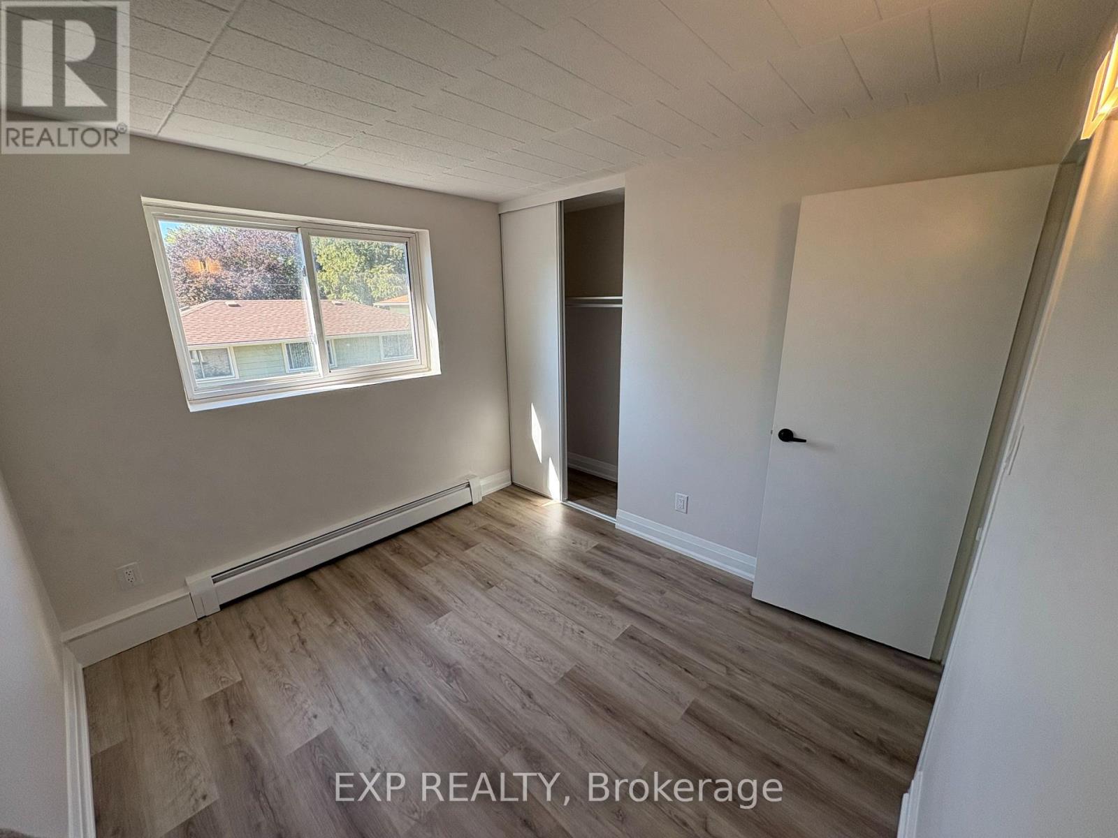 A room with EXP Realty, Brokerage written on the floor.