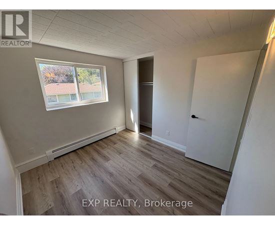 A room with EXP Realty, Brokerage written on the floor.