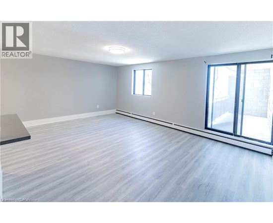 A spacious room with a sliding glass door and a window.