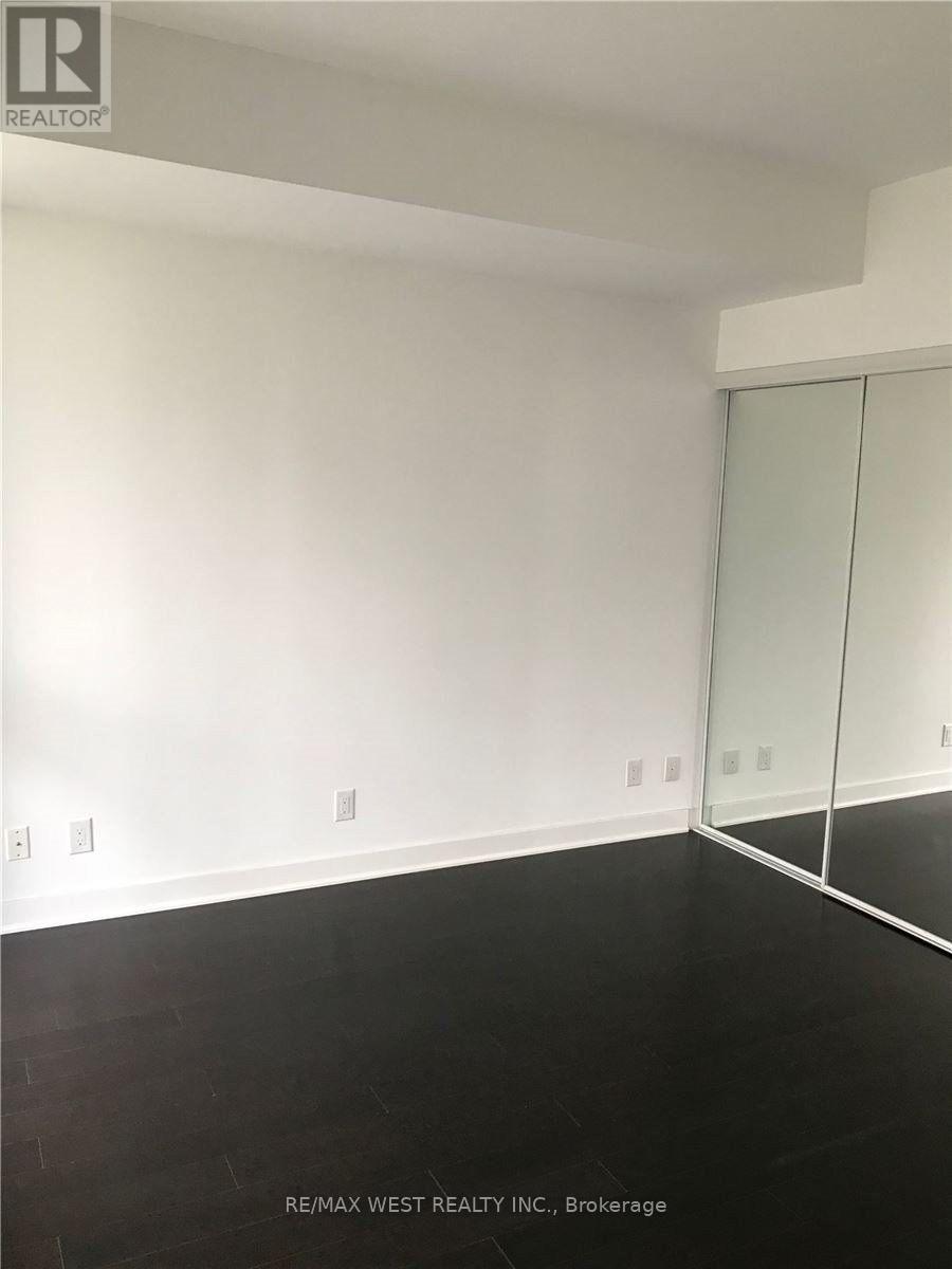 A room with a glass door and a white wall.