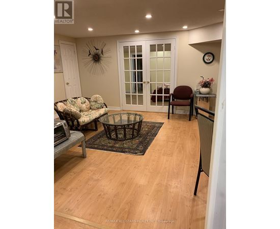 A living room with a couch, chair, and coffee table.