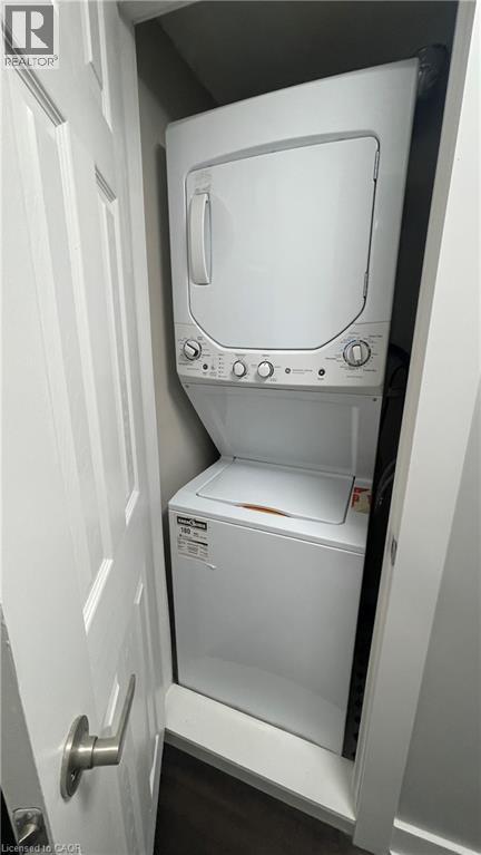 A white oven and microwave are installed in a small kitchen.