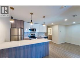 A modern kitchen with a blue countertop and stainless steel appliances.