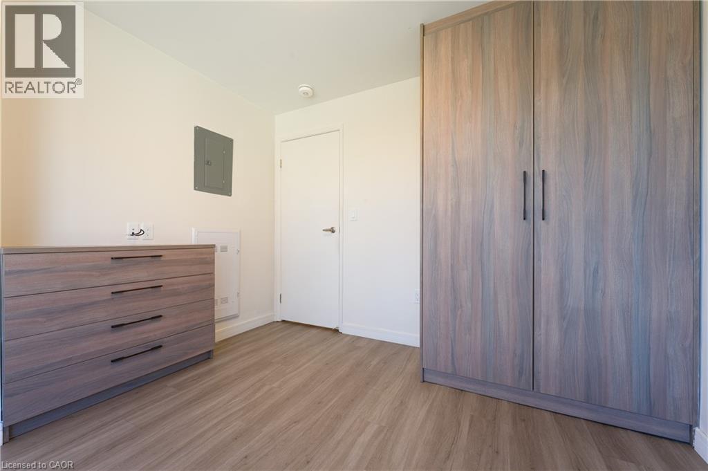 A bedroom with a wooden floor and a large wardrobe.