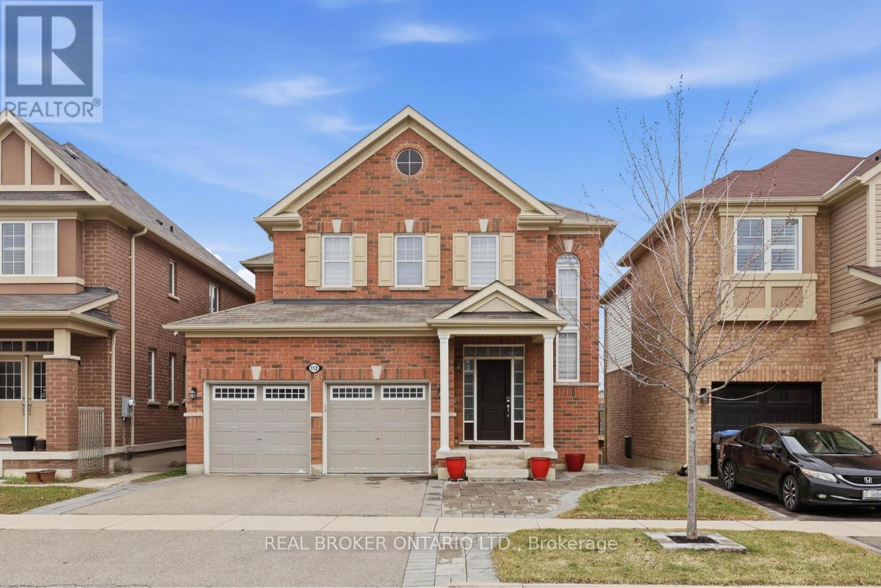 A house with a brick facade and a car parked in front.