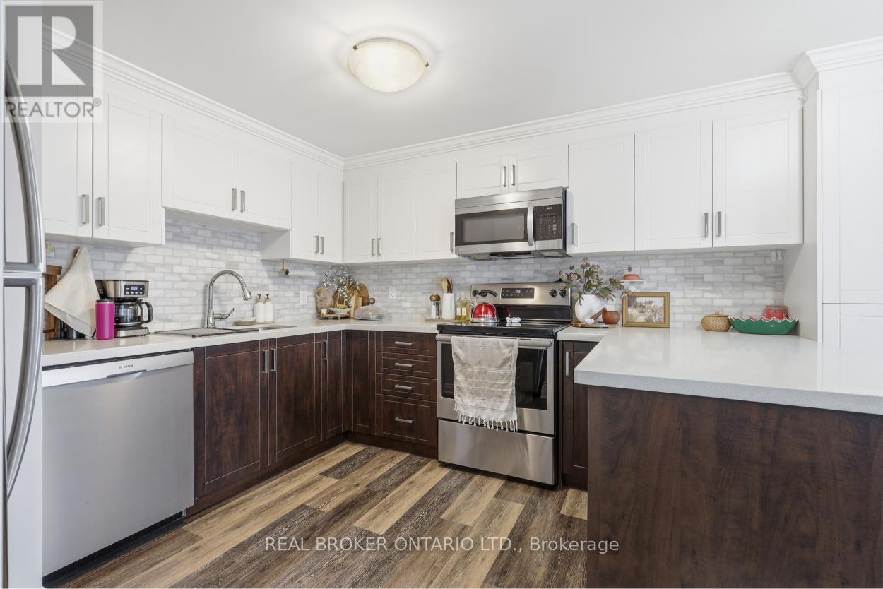 A kitchen with white cabinets and a wooden floor.