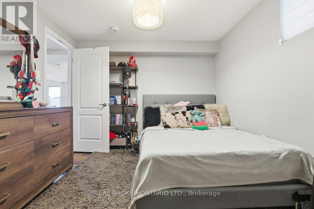 A bedroom with a bed, dresser, and bookshelf.