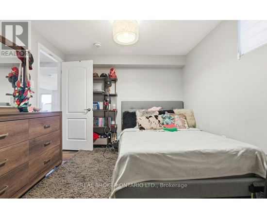 A bedroom with a bed, dresser, and bookshelf.
