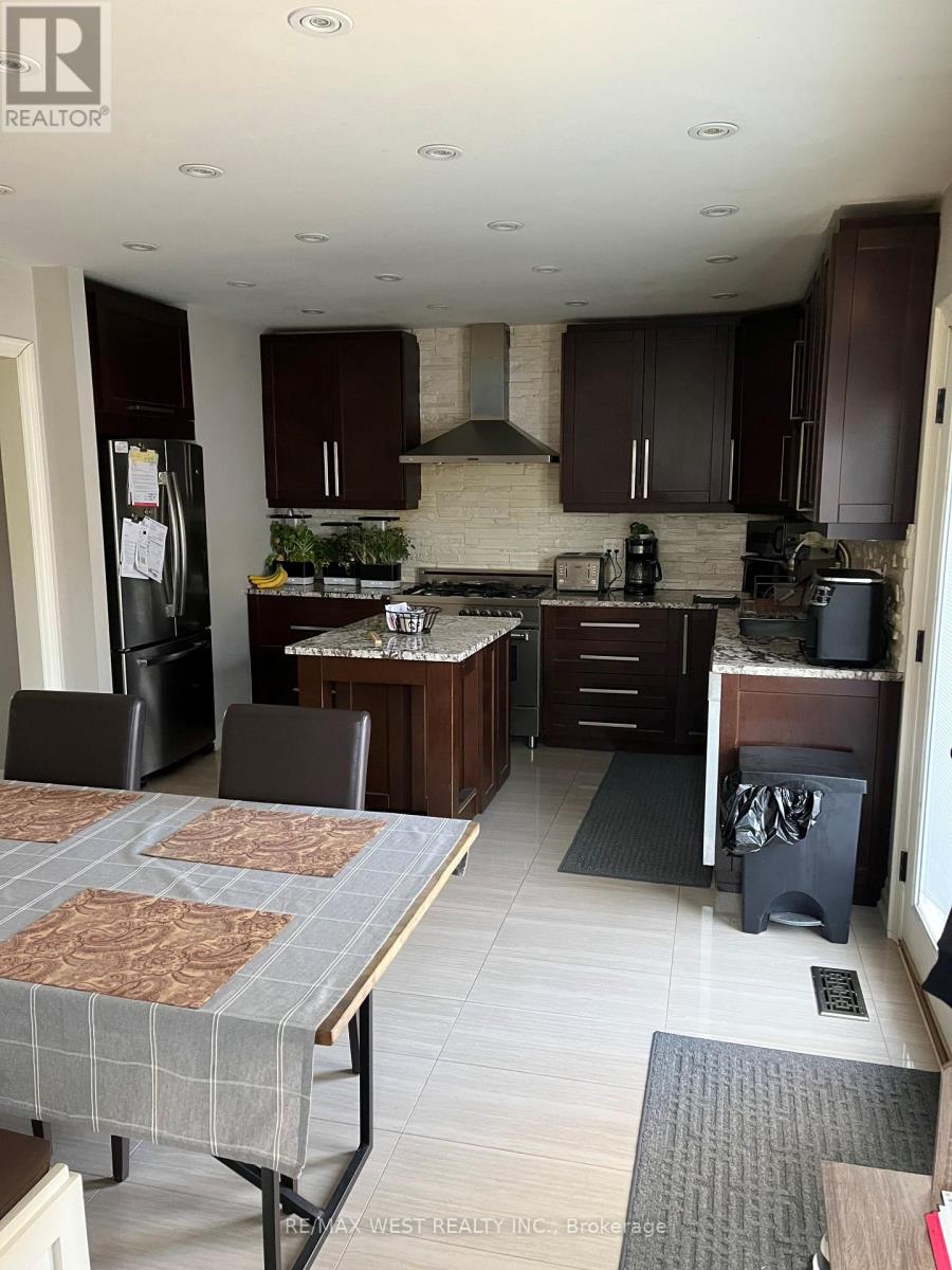 A kitchen with brown cabinets and a table with a placemat on it.