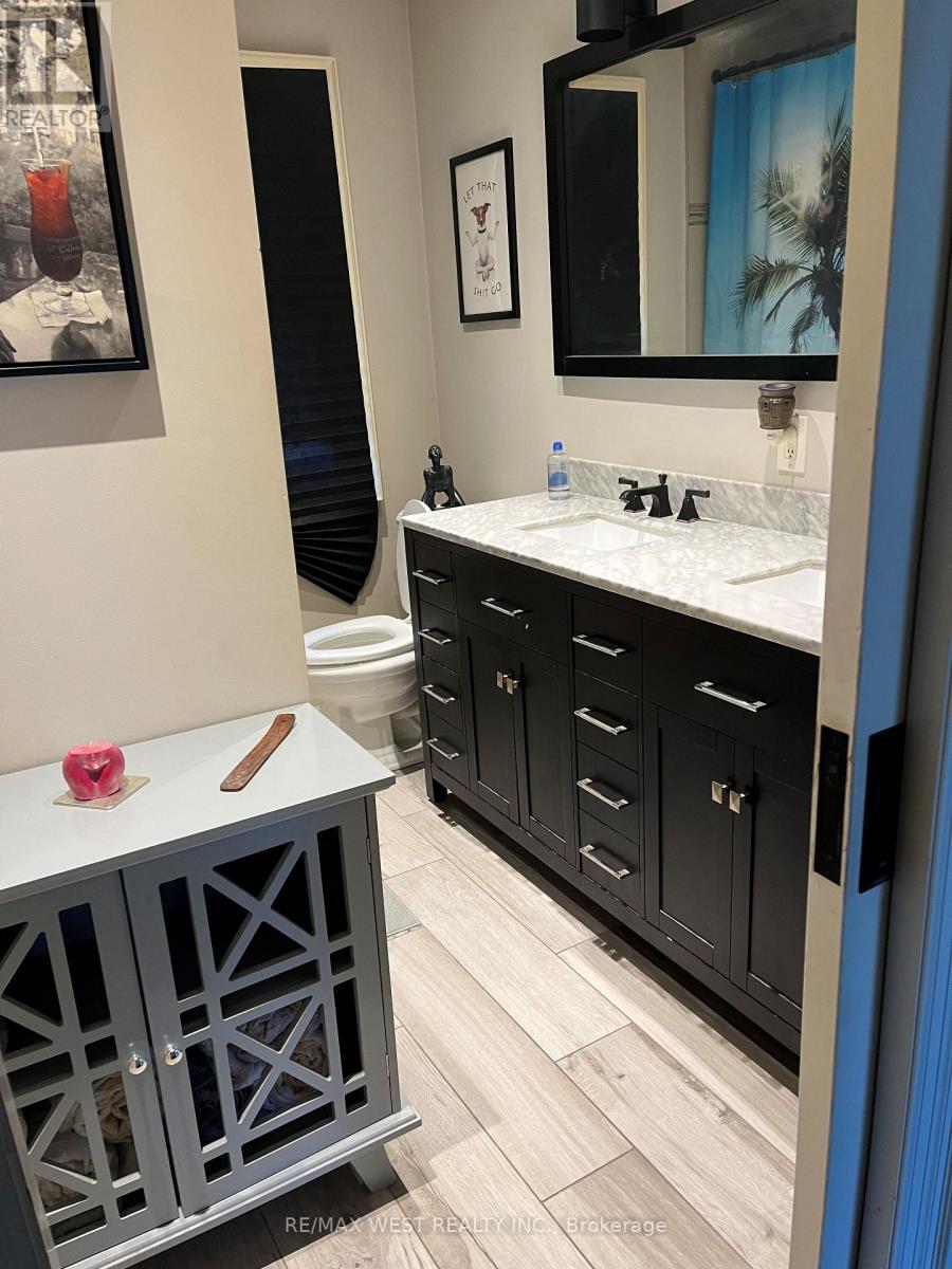 A bathroom with a white counter top and a grey cabinet.