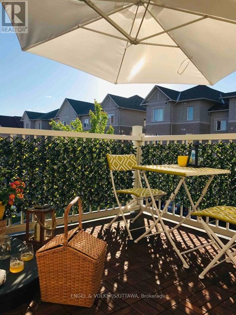 A patio with a table and chairs under an umbrella.