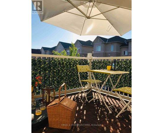 A patio with a table and chairs under an umbrella.