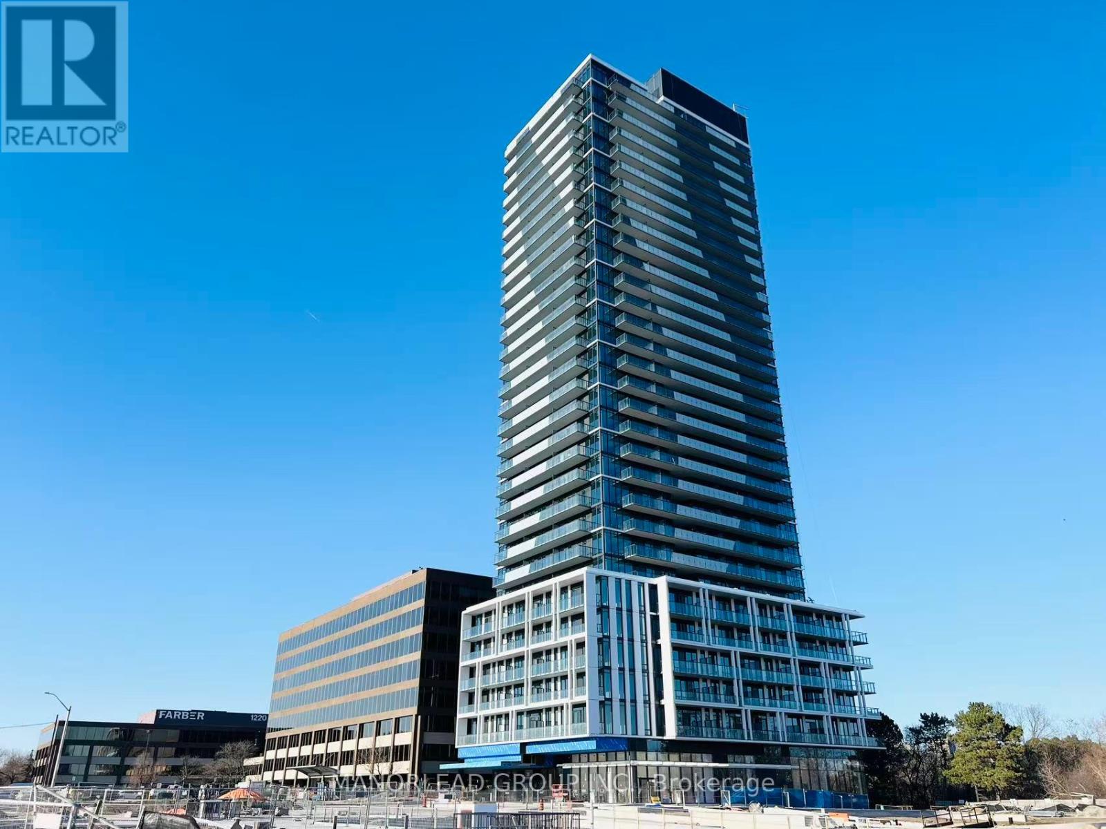 A tall building with many windows is under construction.