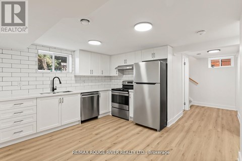 A kitchen with white cabinets and stainless steel appliances.