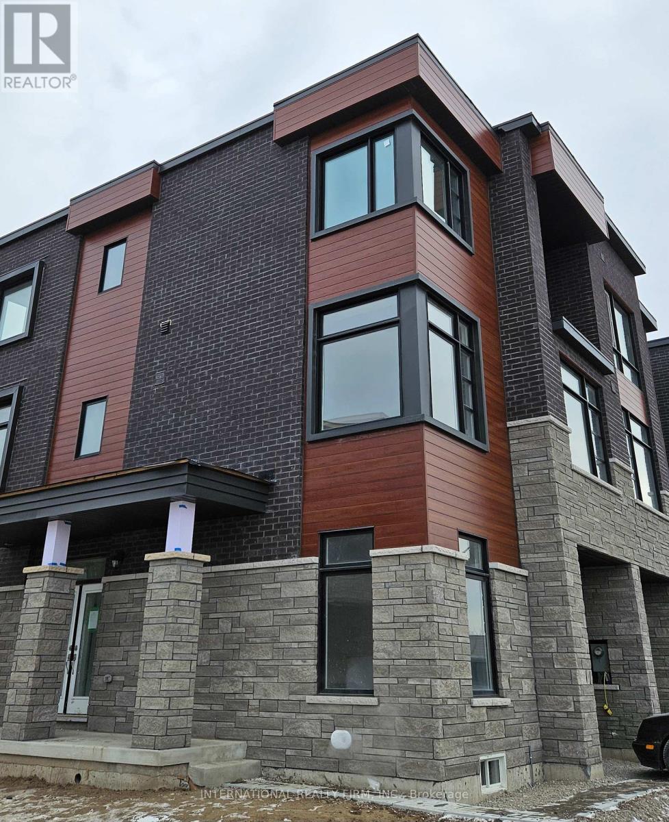 A modern house with a combination of brick and stone exterior.