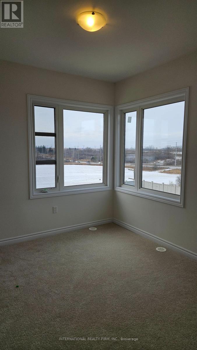 A room with a carpet floor and a window overlooking a snowy landscape.