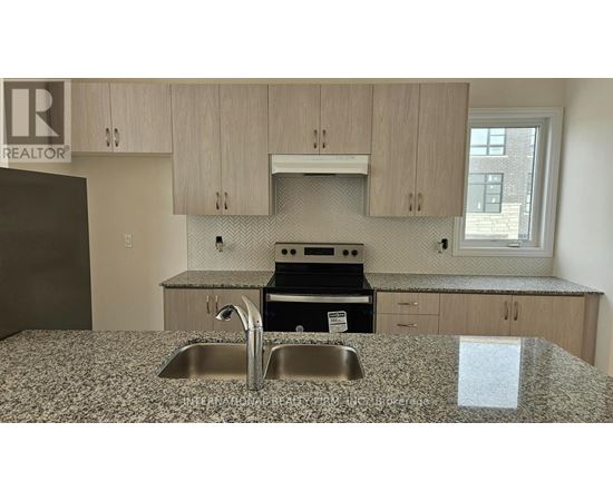 A kitchen with a granite countertop and a sink.