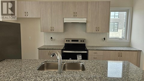 A kitchen with a granite countertop and a sink.