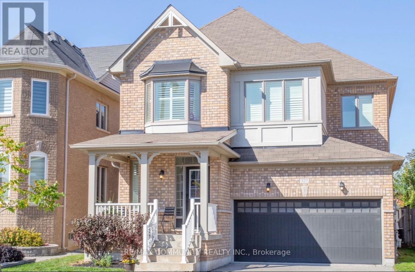 A house with a brown roof and a white garage door.