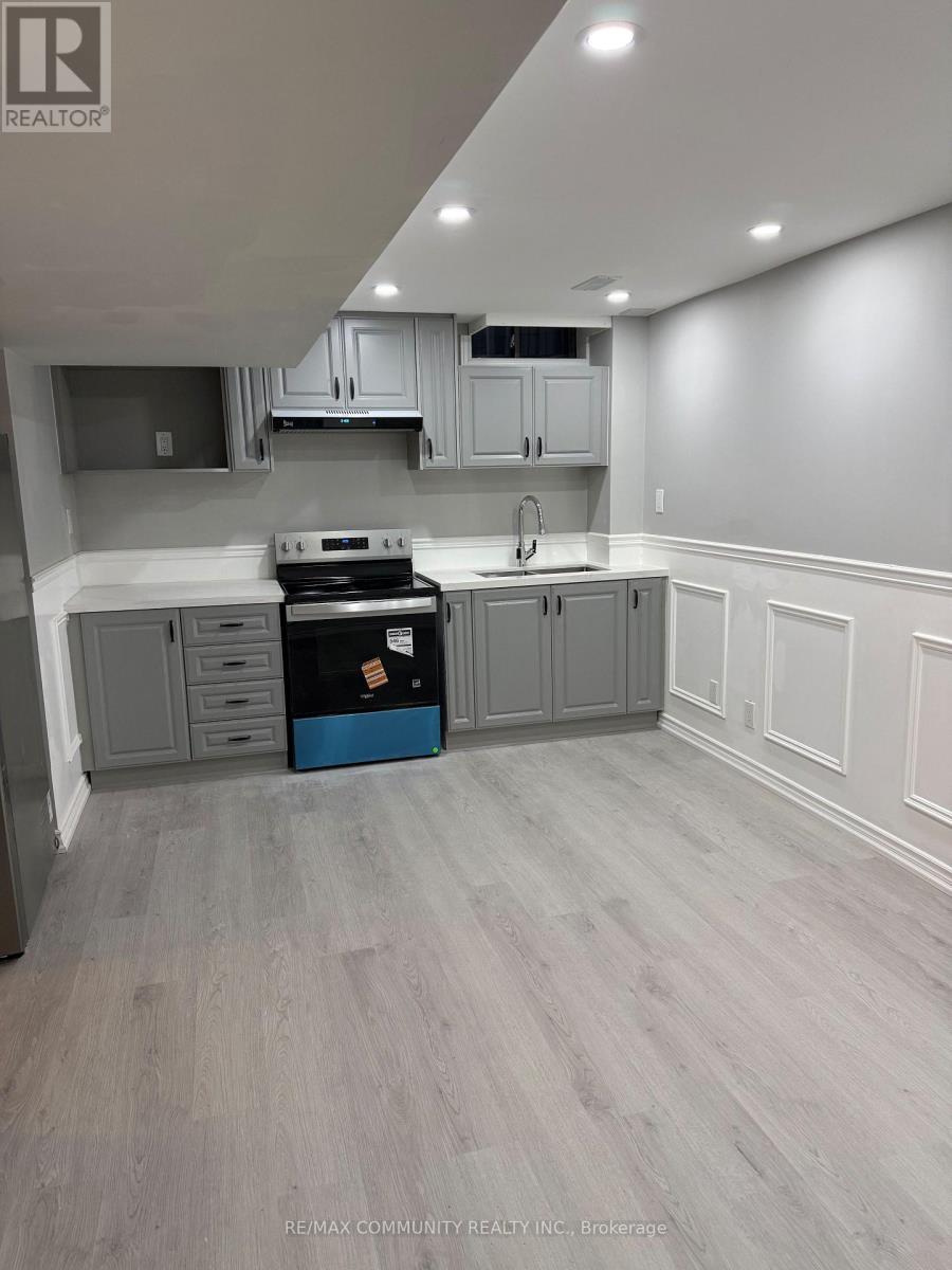 A kitchen with grey cabinets and a blue box on the counter.