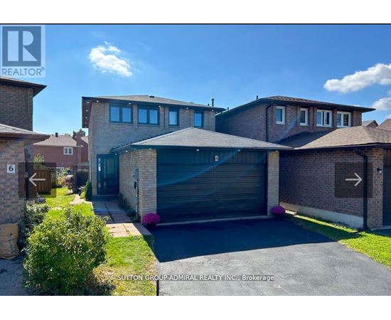 A modern house with a garage is for sale.
