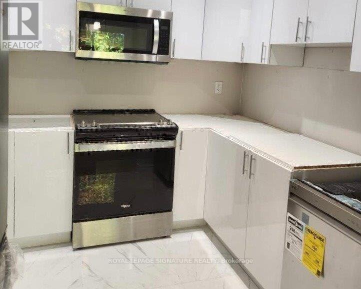 A kitchen with white cabinets and a black stove top oven.