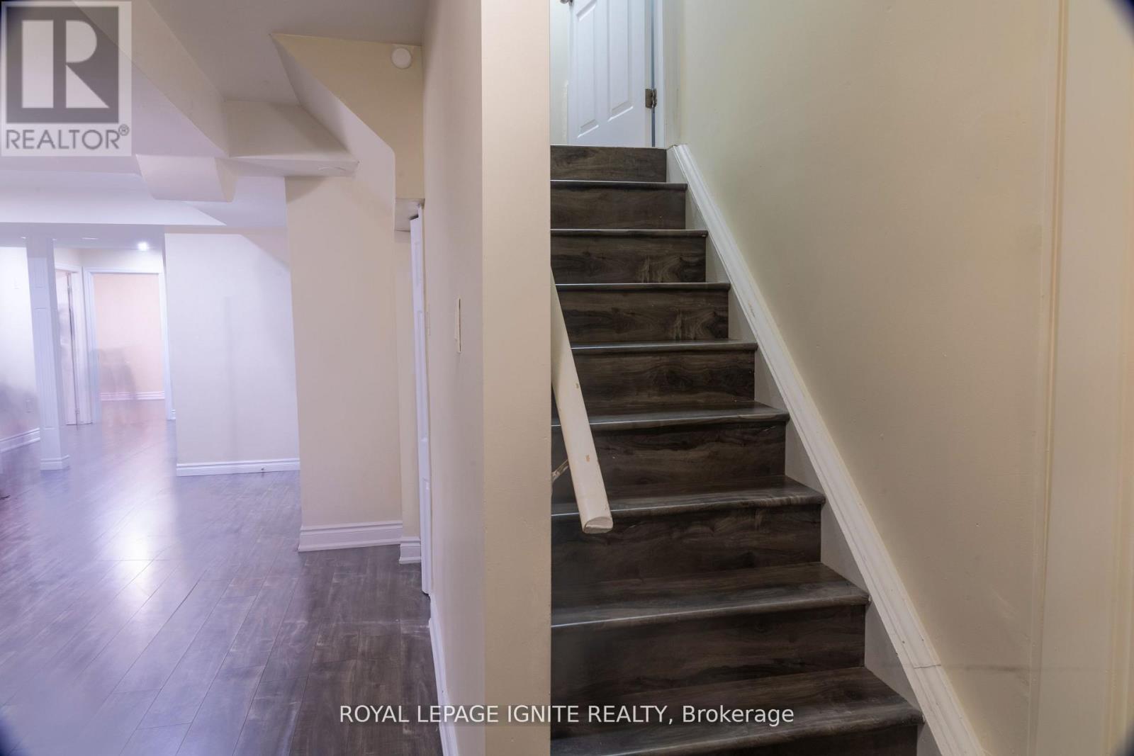 A staircase with wooden steps and white railings.