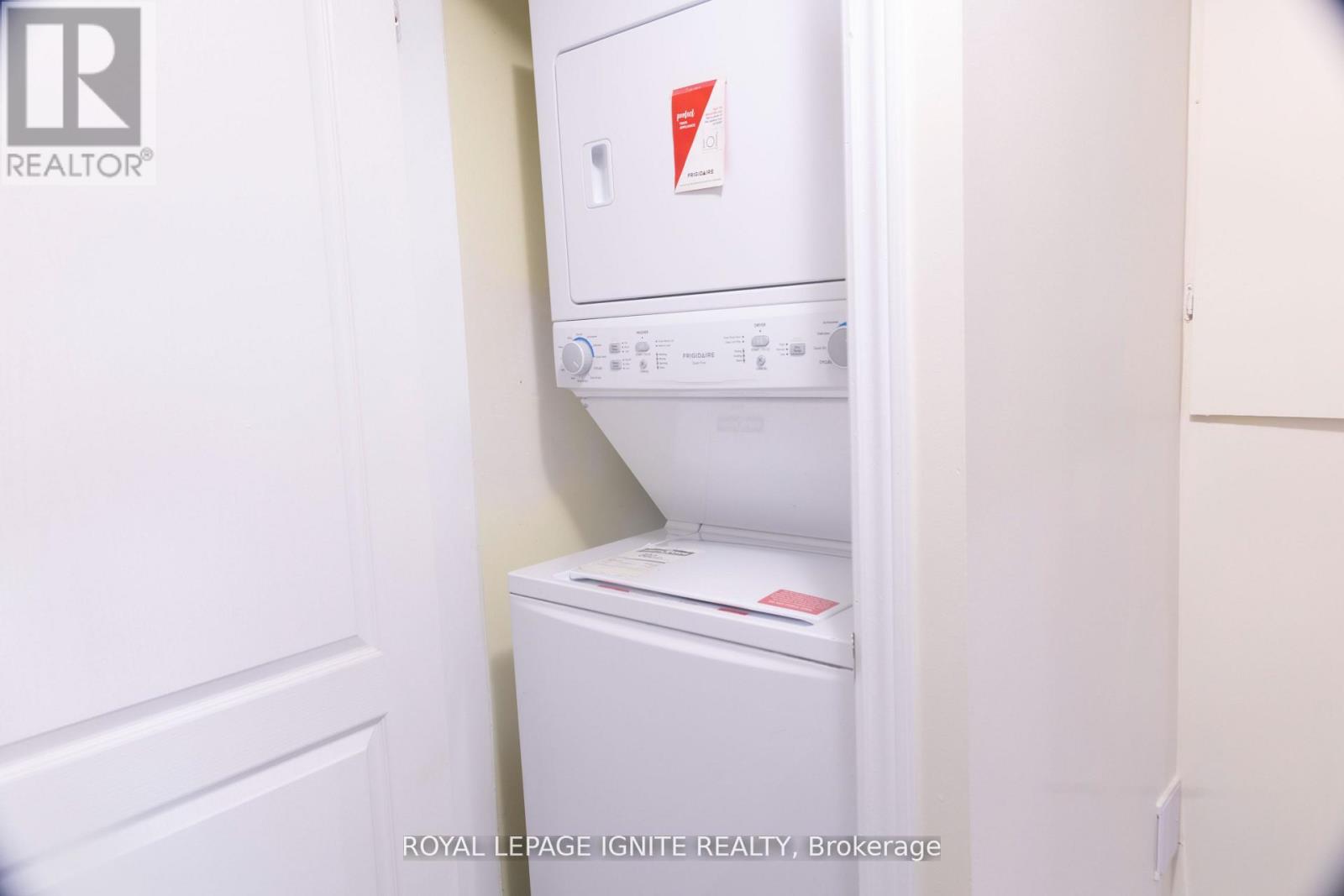 A white dishwasher and refrigerator in a small kitchen.