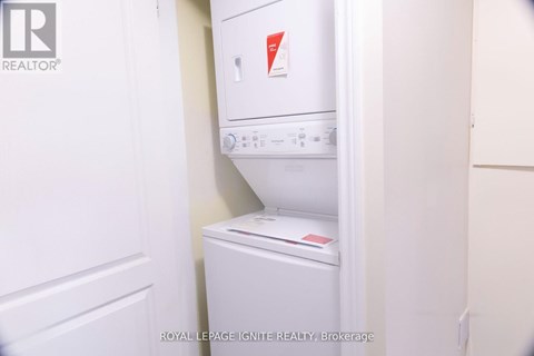 A white dishwasher and refrigerator in a small kitchen.