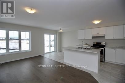 A real estate office is showing a kitchen area in a new property.