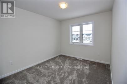 A room with a window and a view of other buildings outside.