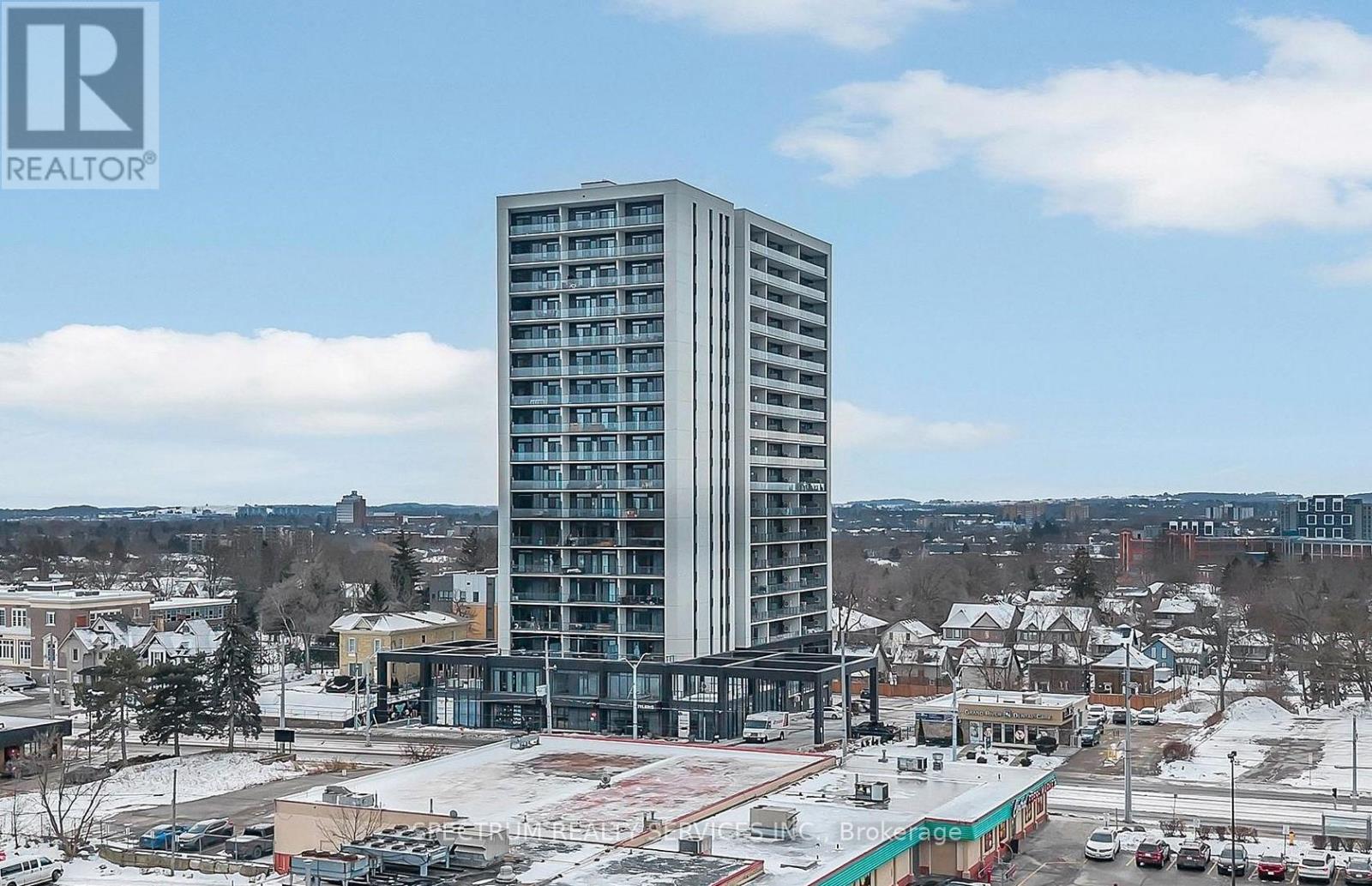 A tall building with many windows is the focal point of the image.