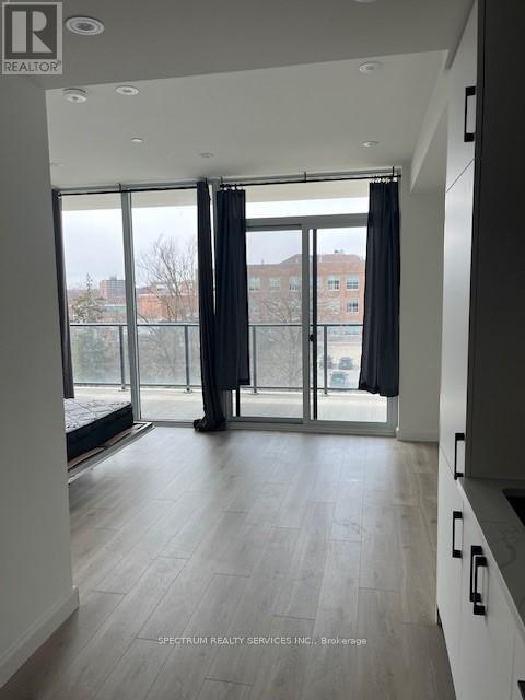 A spacious room with a view of the city through large windows.