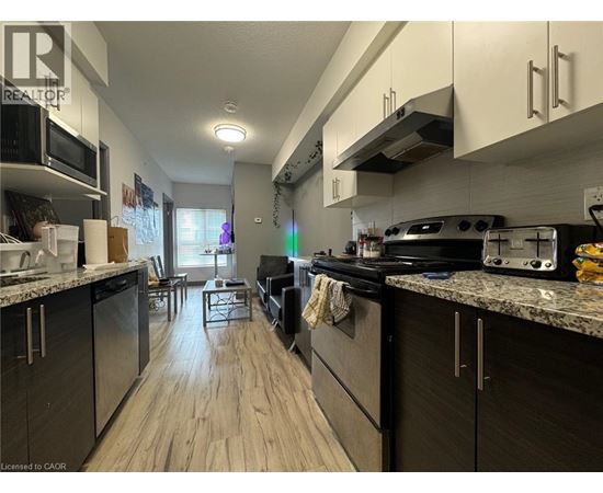 A kitchen with a black stove top oven and a black refrigerator.
