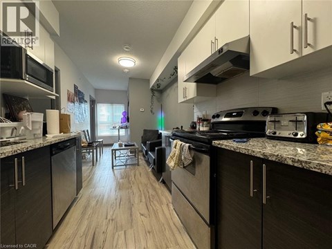 A kitchen with a black stove top oven and a black refrigerator.