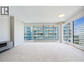 A spacious, well-lit room with large windows overlooking a cityscape.