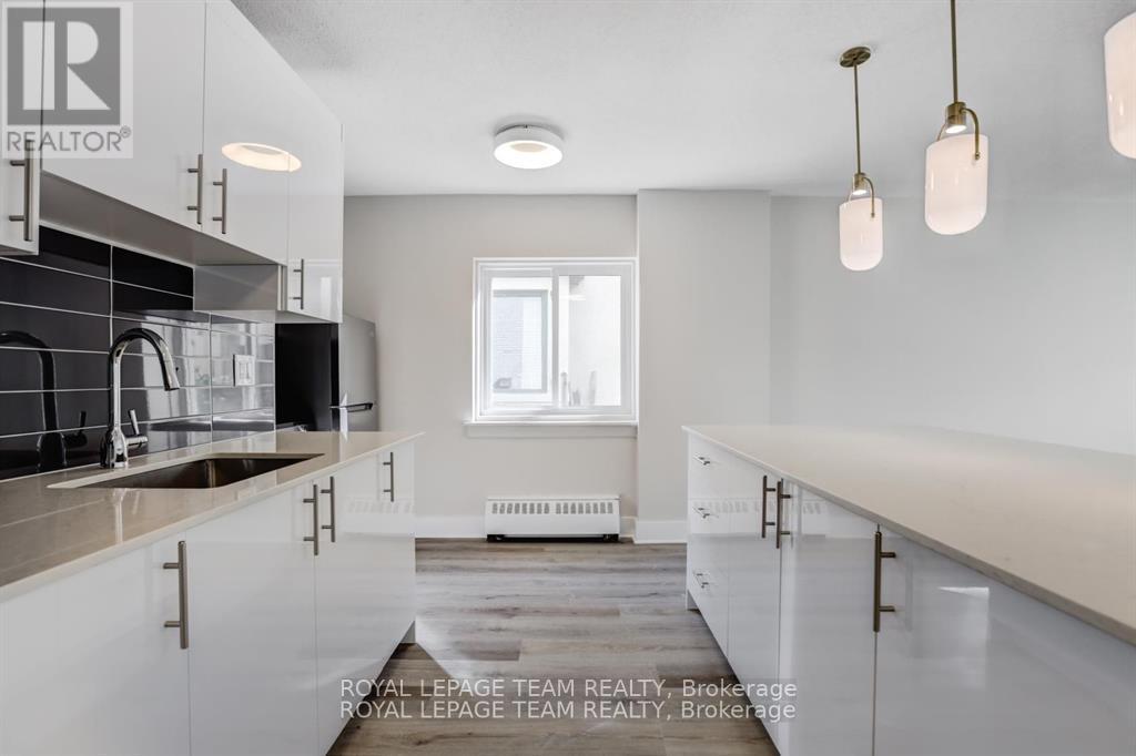 A modern kitchen with white cabinets and a large island.