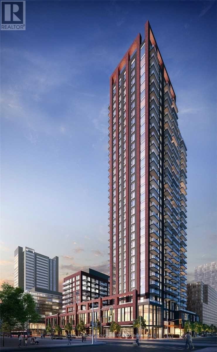 A tall red building with many windows is the main focus of the image.