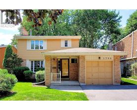 A house with a garage and a driveway is for sale.