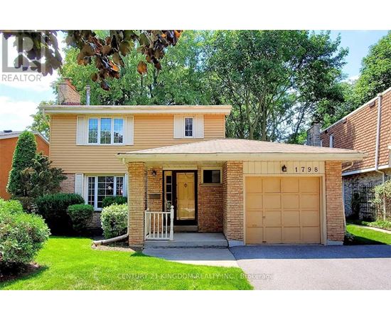 A house with a garage and a driveway is for sale.