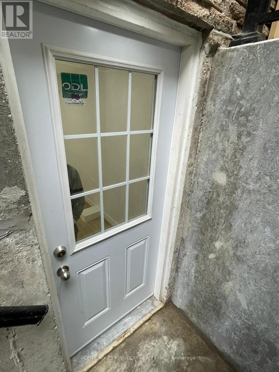 A white door with a glass panel and a sign on it.