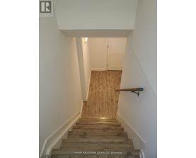 A staircase with wooden steps and a handrail.