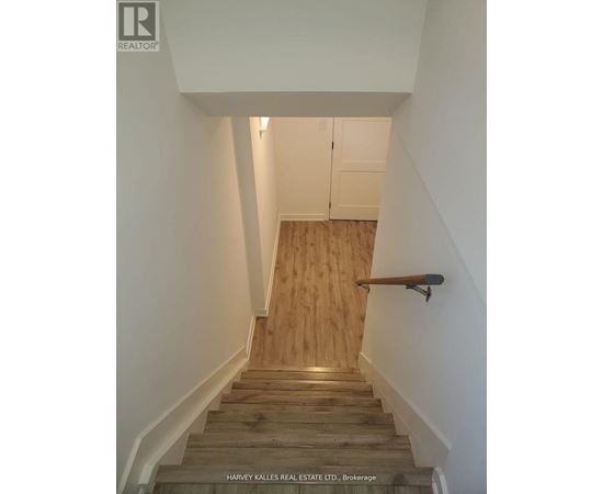 A staircase with wooden steps and a handrail.
